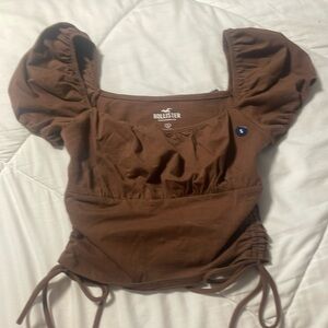 Brown shirt from hollister with ties on sides. size small. brand new.